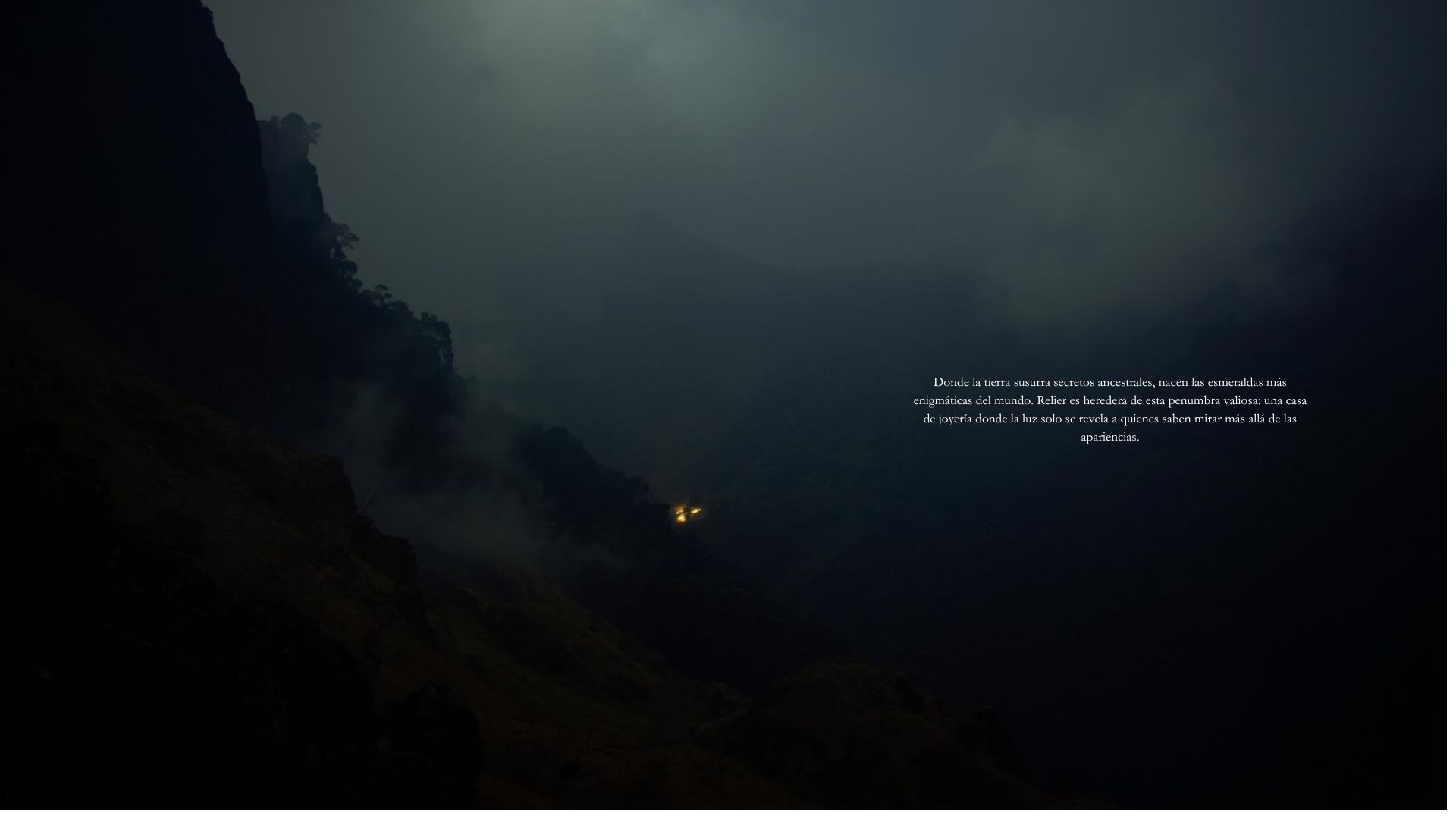Mist drifting across a cliff face, a single distant ember of light.