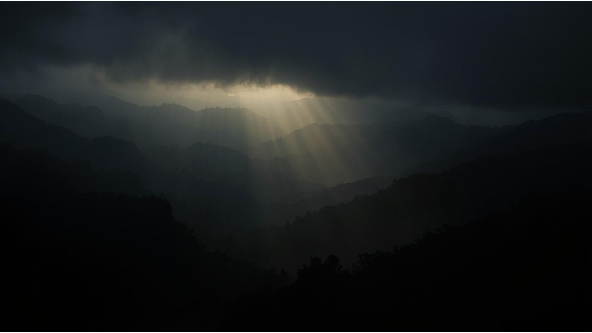 God rays breaking through storm clouds over the cordillera